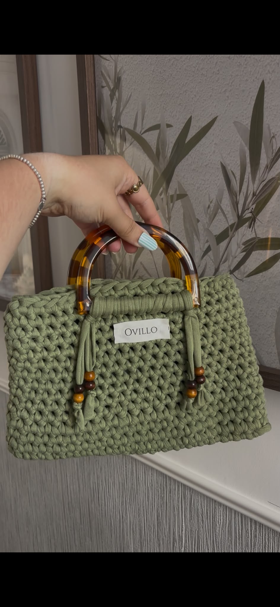 Sage green hand-crocheted handbag with tortoiseshell handle